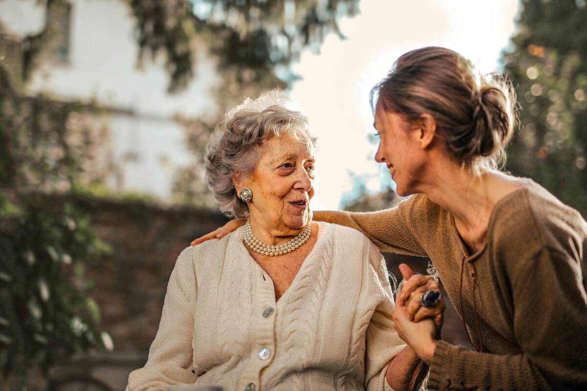 Caregiver supporting an elderly person at home